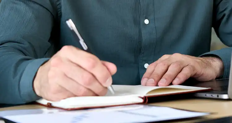 Persona escribiendo en una libreta